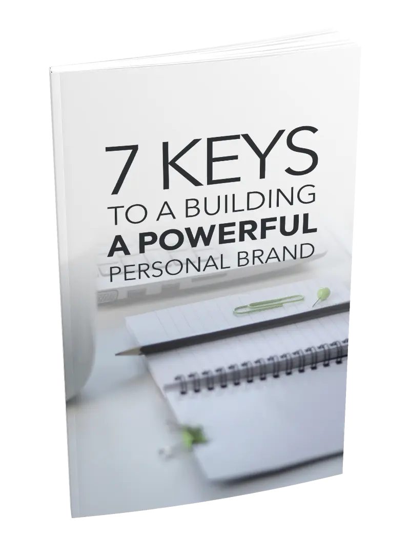 Book titled '7 Keys to a Building a Powerful Personal Brand' with a pen and notebook on a white background